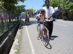 father taking his son home from pre-school, Weligama, Sri Lanka